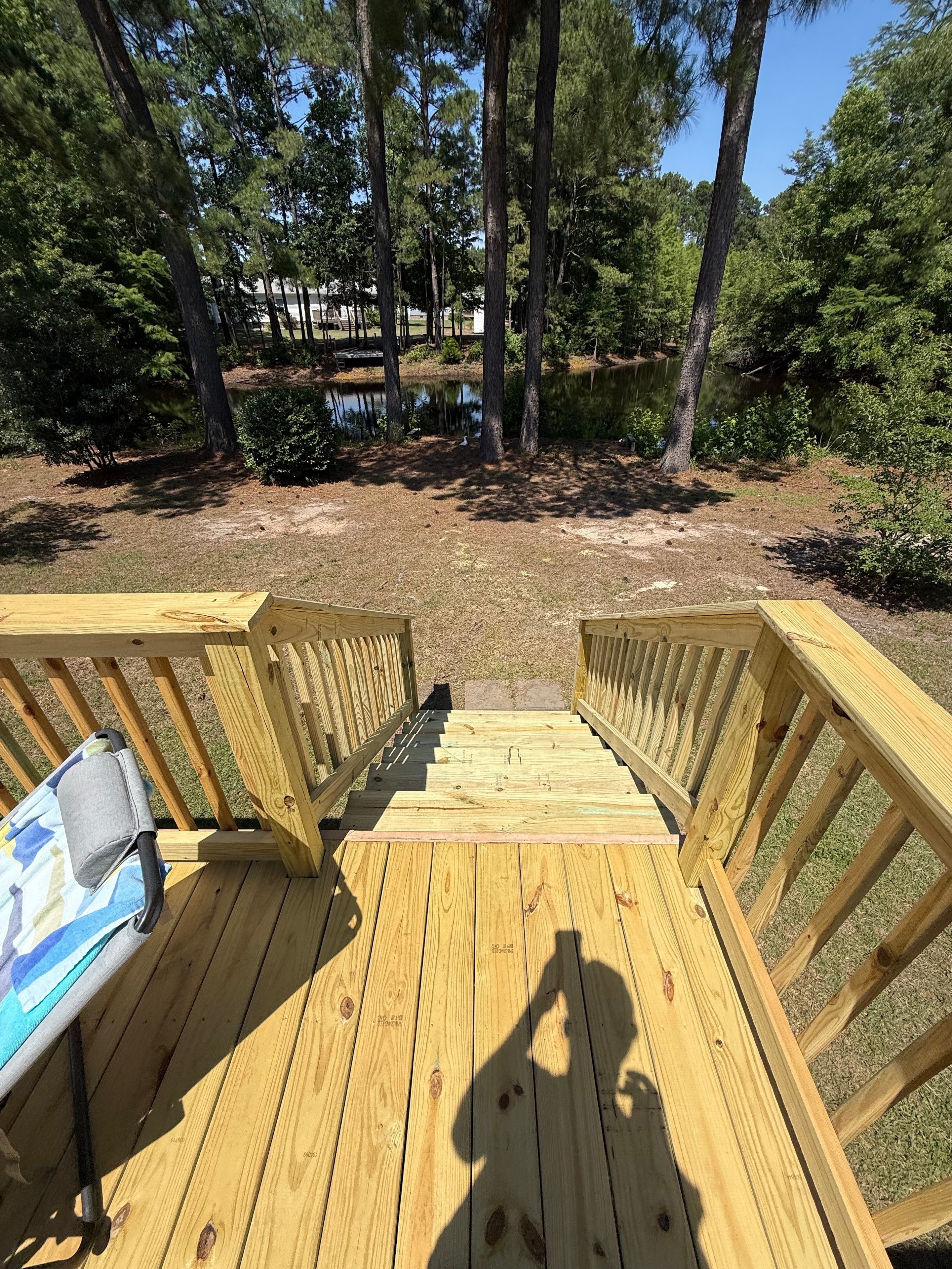 New wooden deck with railing and steps