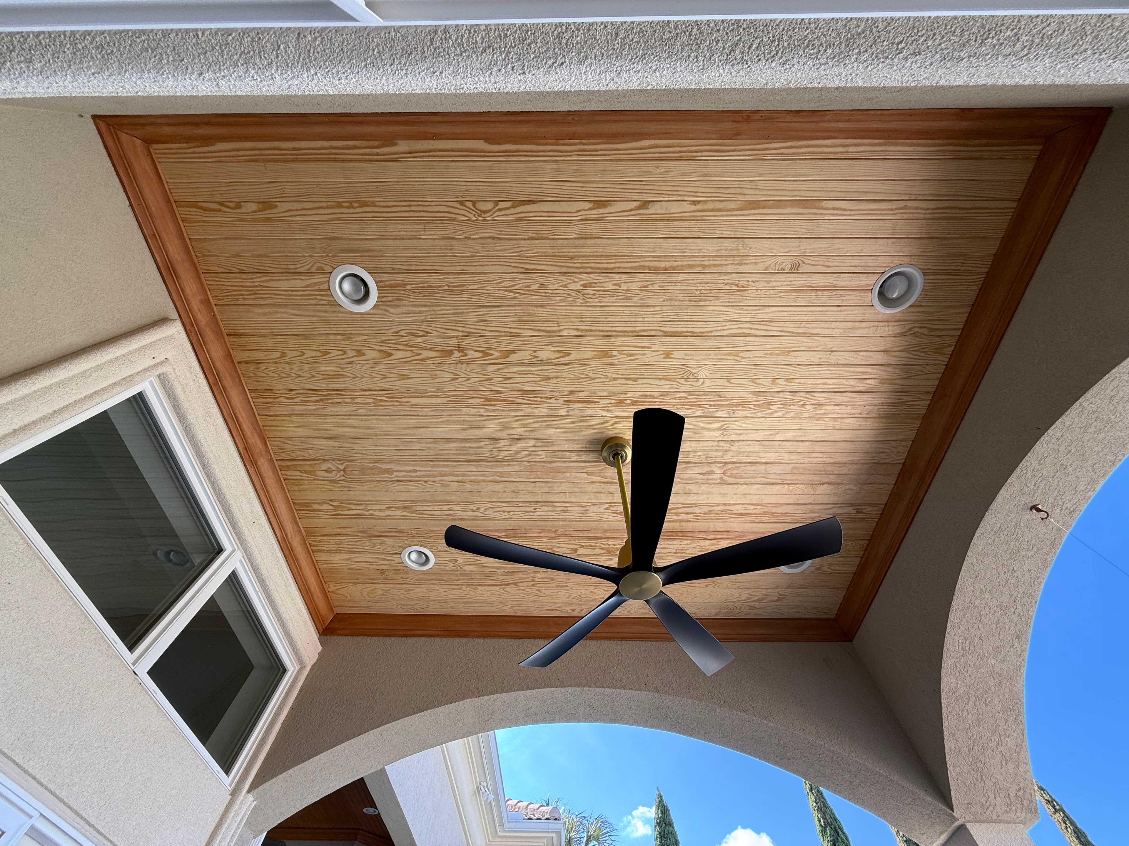 Wood ceiling with ceiling fan installation