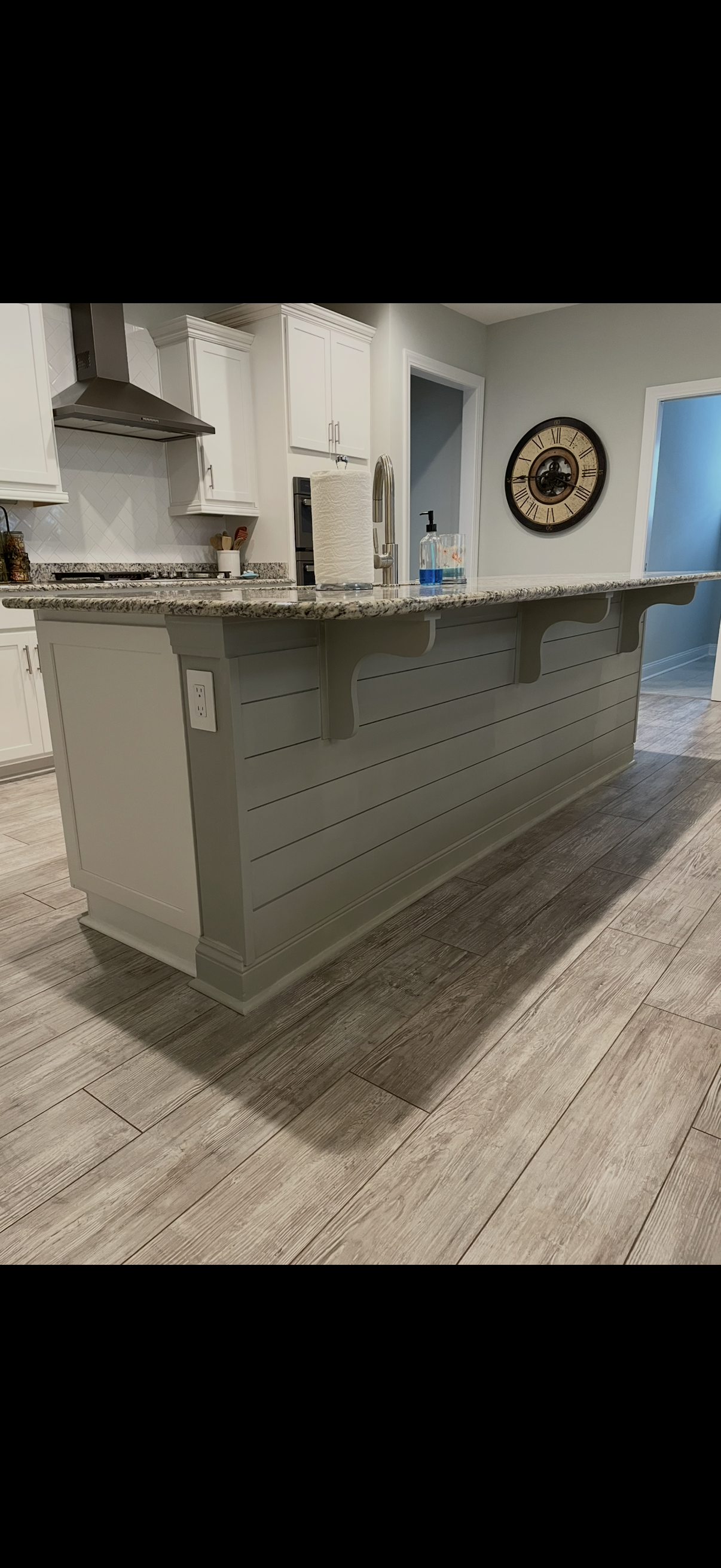 Kitchen island with shiplap and granite countertop