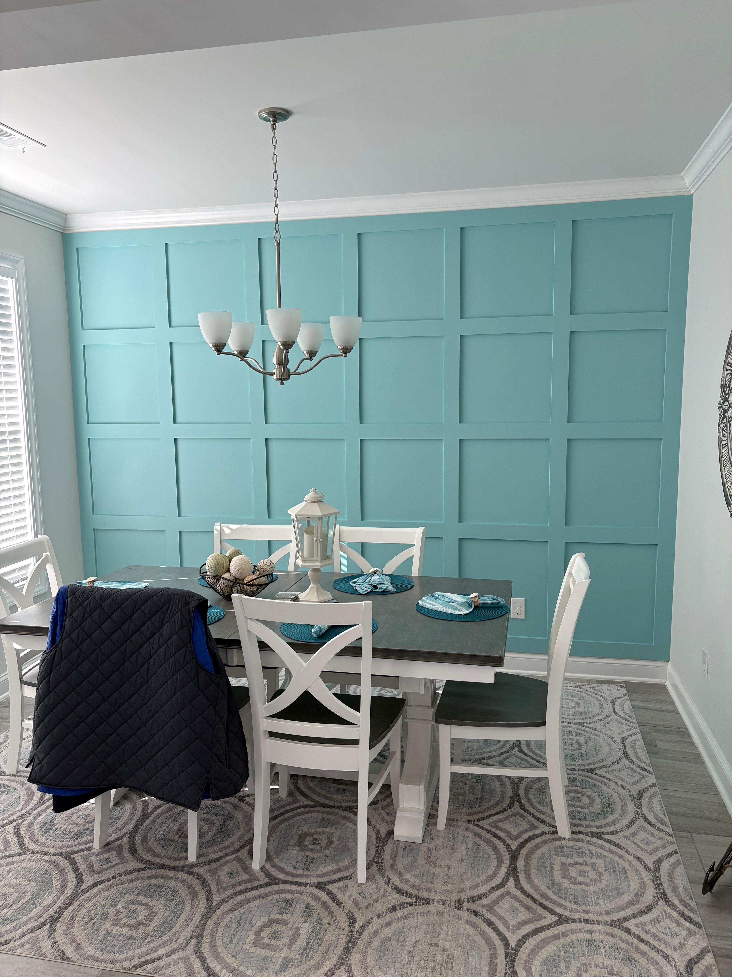 Dining room with teal board and batten accent wall