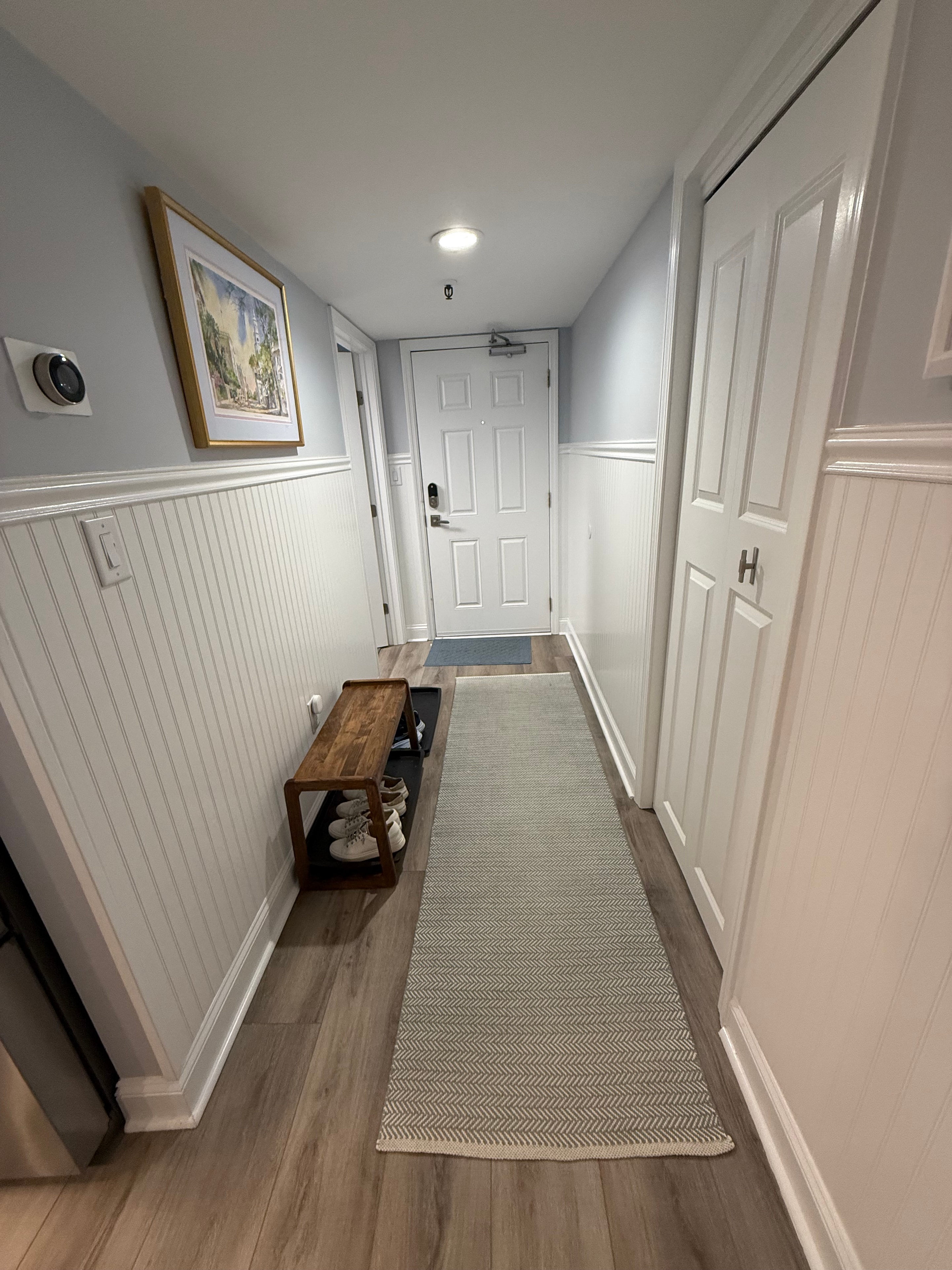 Renovated entryway with beadboard and wood plank wall