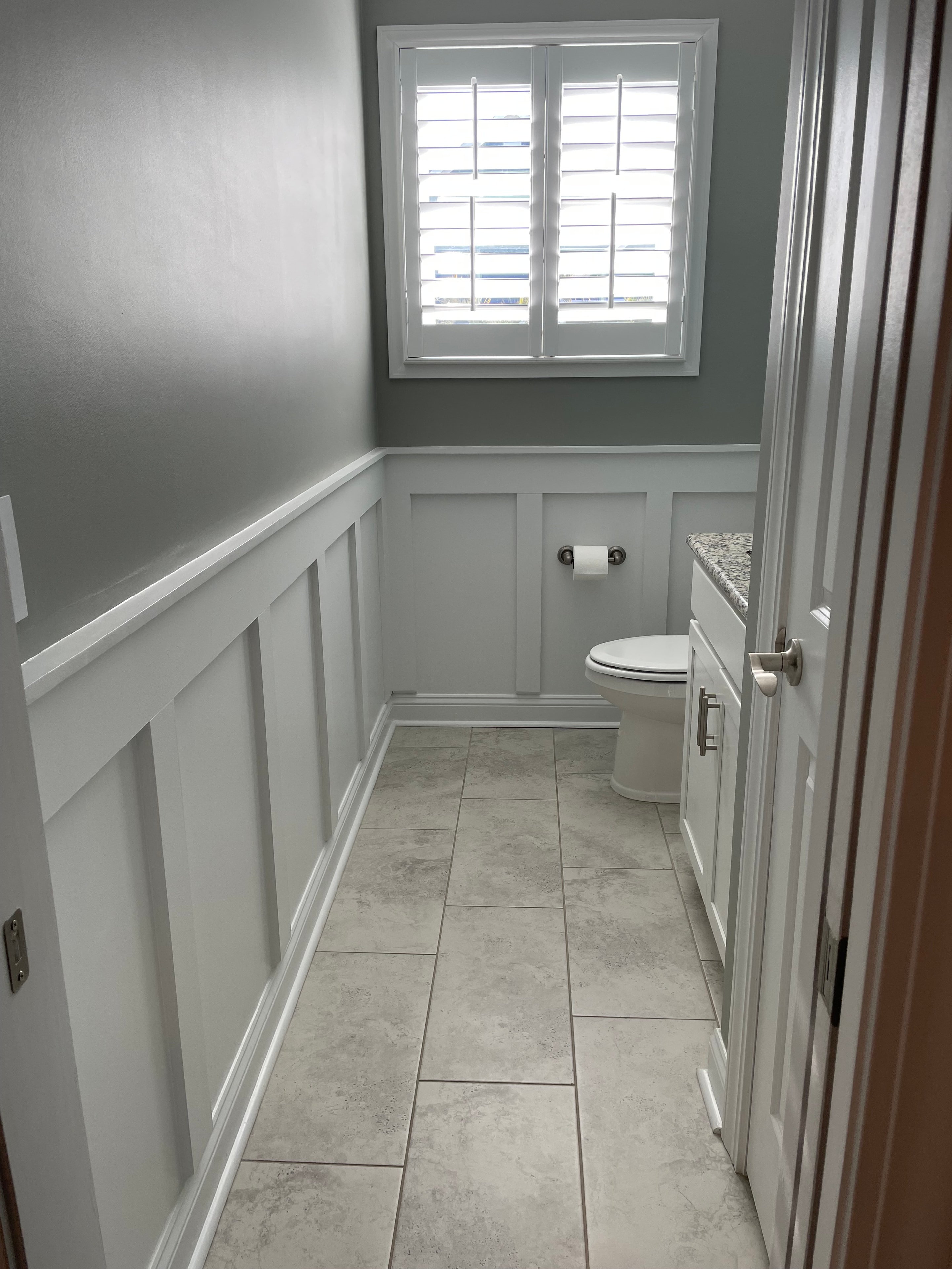 Bathroom renovation with board and batten, tile, and window